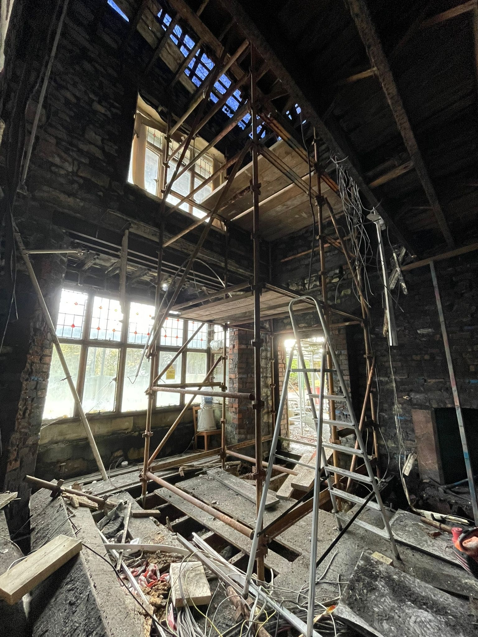 Interior scaffolding inside Coed Parc during restoration, showing the scale of repair work required to the historic building fabric